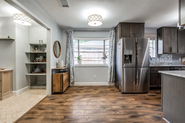 309 Westpark Dr N, Mckinney, TX 75071 - kitchen with stainless steel refrigerator with ice dispenser, dark brown cabinets, healthy amount of natural light, and light stone counters