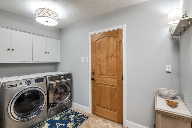 309 Westpark Dr N, Mckinney, TX 75071 - laundry room with cabinet space, washer and dryer, baseboards, light stone finish flooring, and a textured ceiling