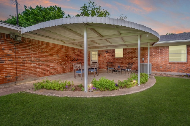 309 Westpark Dr N, Mckinney, TX 75071 - patio terrace at dusk featuring a lawn, central air condition unit, and a patio area