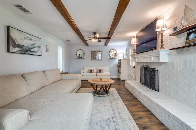 309 Westpark Dr N, Mckinney, TX 75071 - living area featuring a ceiling fan, dark wood-type flooring, a fireplace, beam ceiling, and baseboards