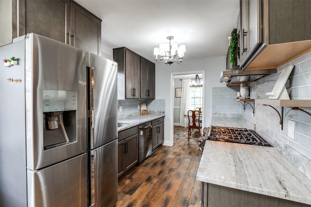 309 Westpark Dr N, Mckinney, TX 75071 - kitchen featuring appliances with stainless steel finishes, a chandelier, tasteful backsplash, dark brown cabinetry, and dark wood-style floors