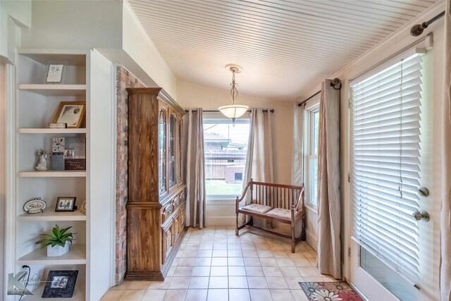 1001 Chriswood Dr, Abilene, TX 79601 - living area with built in shelves, vaulted ceiling, and light tile patterned floors