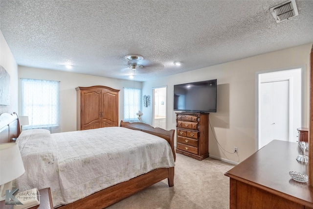 1001 Chriswood Dr, Abilene, TX 79601 - bedroom with light carpet, baseboards, a ceiling fan, and a textured ceiling