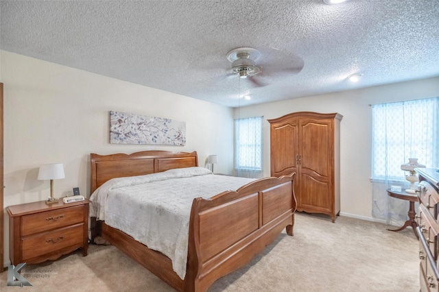 1001 Chriswood Dr, Abilene, TX 79601 - bedroom featuring light colored carpet, ceiling fan, a textured ceiling, and baseboards