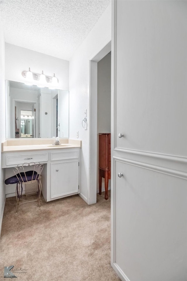 1001 Chriswood Dr, Abilene, TX 79601 - bathroom featuring vanity, a textured ceiling, and baseboards