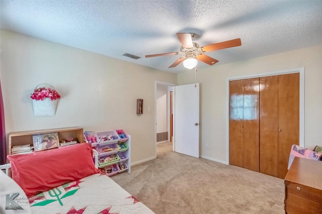 1001 Chriswood Dr, Abilene, TX 79601 - carpeted bedroom featuring a closet, a ceiling fan, baseboards, and a textured ceiling