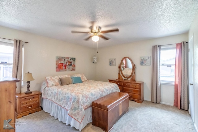 1001 Chriswood Dr, Abilene, TX 79601 - bedroom with light carpet, ceiling fan, a textured ceiling, and baseboards