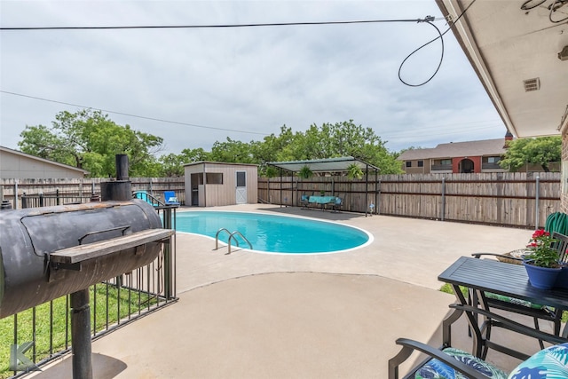 1001 Chriswood Dr, Abilene, TX 79601 - view of pool with a fenced backyard, a patio, a storage unit, and an outbuilding