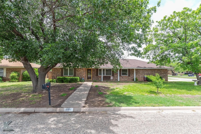 1001 Chriswood Dr, Abilene, TX 79601 - view of front facade featuring a front yard and brick siding