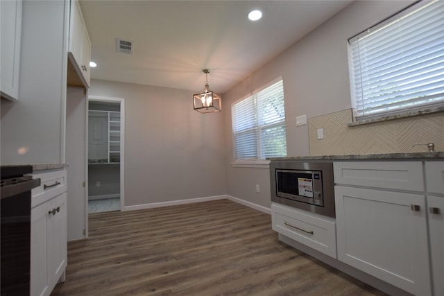 7921 Oak Pkwy, Burleson, TX 76028 - kitchen featuring recessed lighting, dark wood-type flooring, stainless steel microwave, a chandelier, and white cabinets