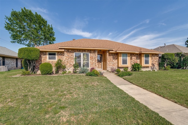 3506 Carla Dr, Rowlett, TX 75088 - view of front of house featuring a front yard, central AC, a shingled roof, and brick siding