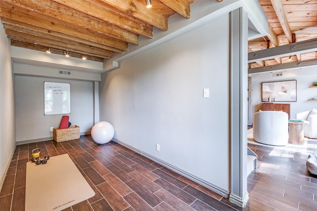 6802 Hammond Ave, Dallas, TX 75223 - below grade area with dark wood-type flooring, rail lighting, and baseboards