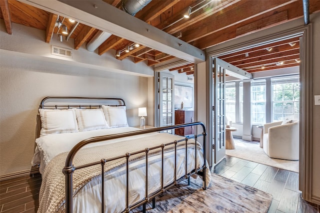6802 Hammond Ave, Dallas, TX 75223 - bedroom with wood finish floors, beam ceiling, and baseboards