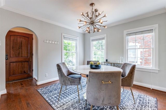 6802 Hammond Ave, Dallas, TX 75223 - dining room with dark wood-style flooring, crown molding, a chandelier, baseboards, and arched walkways