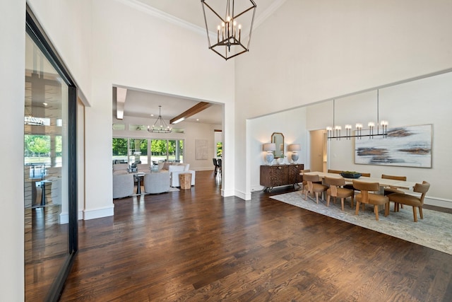 2012 Honey Ln, Celina, TX 75009 - dining area with a chandelier, wood finished floors, baseboards, a towering ceiling, and ornamental molding
