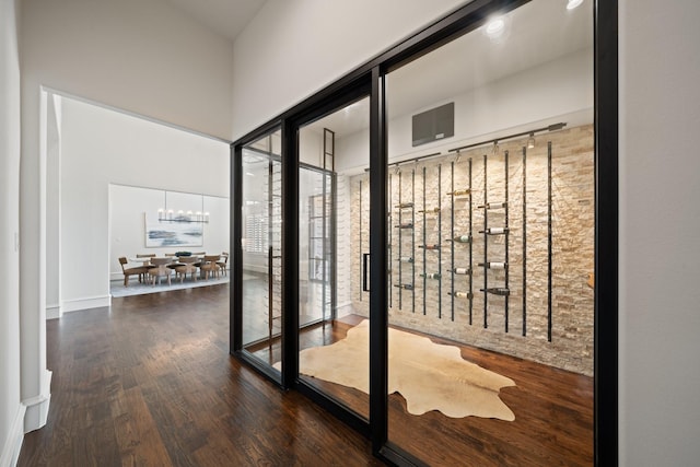 2012 Honey Ln, Celina, TX 75009 - wine room featuring wood finished floors, a high ceiling, and a chandelier