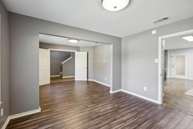 8808 Eastwood Ave, Cross Roads, TX 76227 - unfurnished room featuring dark wood-type flooring, stairway, and baseboards