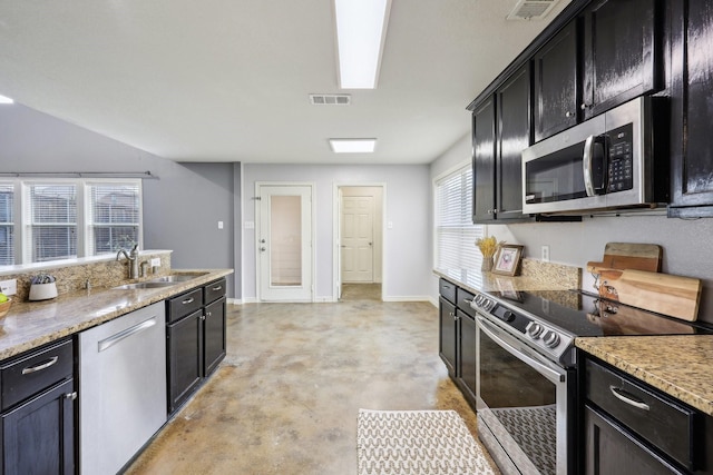 8808 Eastwood Ave, Cross Roads, TX 76227 - kitchen featuring stainless steel appliances, a sink, concrete flooring, dark cabinetry, and baseboards
