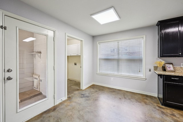 8808 Eastwood Ave, Cross Roads, TX 76227 - kitchen with dark cabinetry, baseboards, and light stone counters