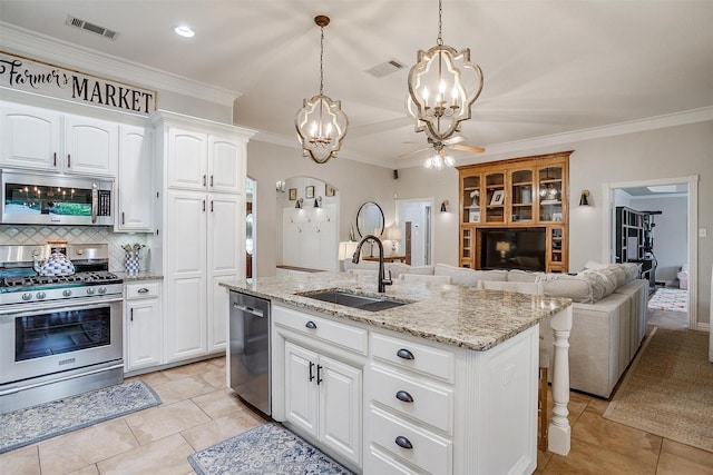 725 Bluebird St, Fort Worth, TX 76140 - kitchen featuring appliances with stainless steel finishes, a chandelier, a sink, light stone countertops, and decorative backsplash