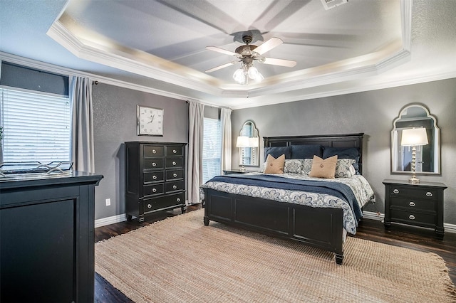 725 Bluebird St, Fort Worth, TX 76140 - bedroom with a tray ceiling, wood finished floors, ornamental molding, a textured wall, and baseboards