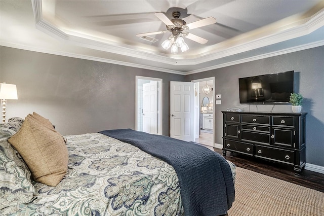 725 Bluebird St, Fort Worth, TX 76140 - bedroom with a tray ceiling, crown molding, dark wood-style floors, a textured wall, and ceiling fan