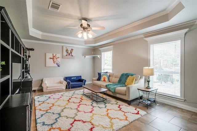 725 Bluebird St, Fort Worth, TX 76140 - living area with a raised ceiling, ceiling fan, ornamental molding, baseboards, and tile patterned floors