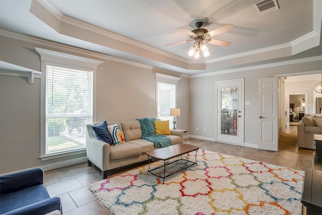 725 Bluebird St, Fort Worth, TX 76140 - living room with a raised ceiling, light tile patterned floors, a ceiling fan, crown molding, and baseboards