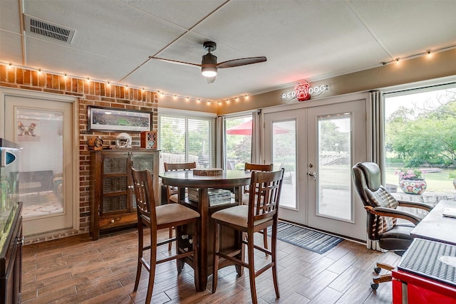 725 Bluebird St, Fort Worth, TX 76140 - dining space with french doors, ceiling fan, wood finished floors, and healthy amount of natural light