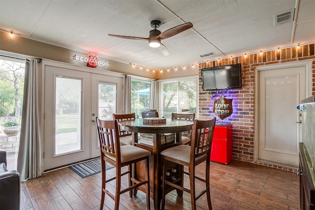 725 Bluebird St, Fort Worth, TX 76140 - dining space with wood finished floors, ceiling fan, and brick wall