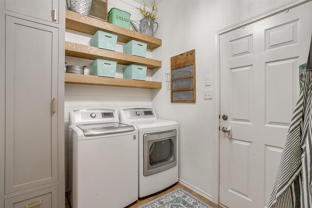725 Bluebird St, Fort Worth, TX 76140 - laundry area featuring washing machine and clothes dryer, light wood finished floors, and baseboards