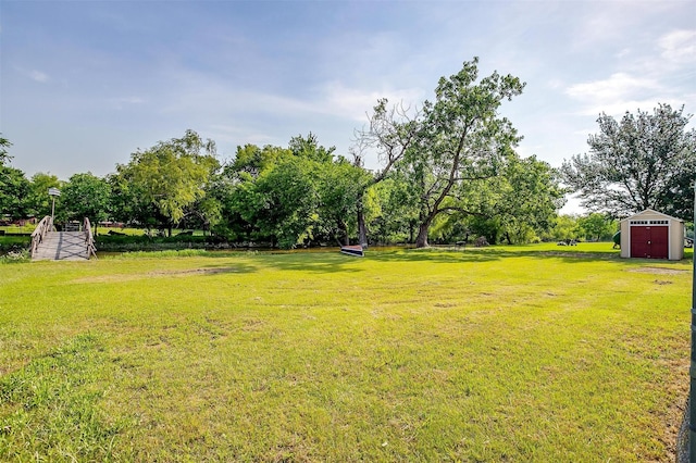 725 Bluebird St, Fort Worth, TX 76140 - view of grassy yard featuring a shed, an outbuilding, and view of scattered trees