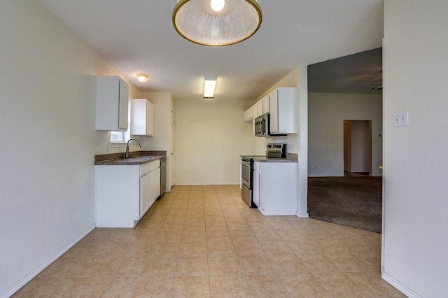 307 Apache Trl, Alvarado, TX 76009 - kitchen with appliances with stainless steel finishes, dark countertops, a sink, and white cabinetry