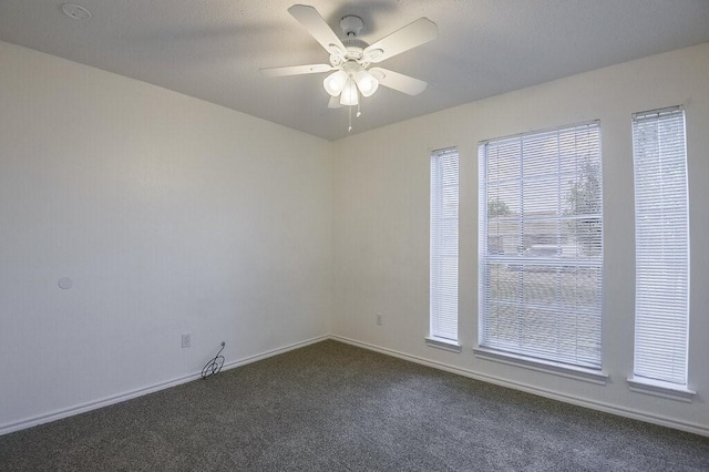 307 Apache Trl, Alvarado, TX 76009 - spare room with dark colored carpet, a ceiling fan, and baseboards