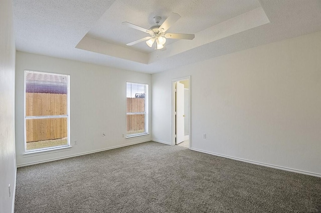 307 Apache Trl, Alvarado, TX 76009 - carpeted empty room with a tray ceiling, ceiling fan, baseboards, and a textured ceiling