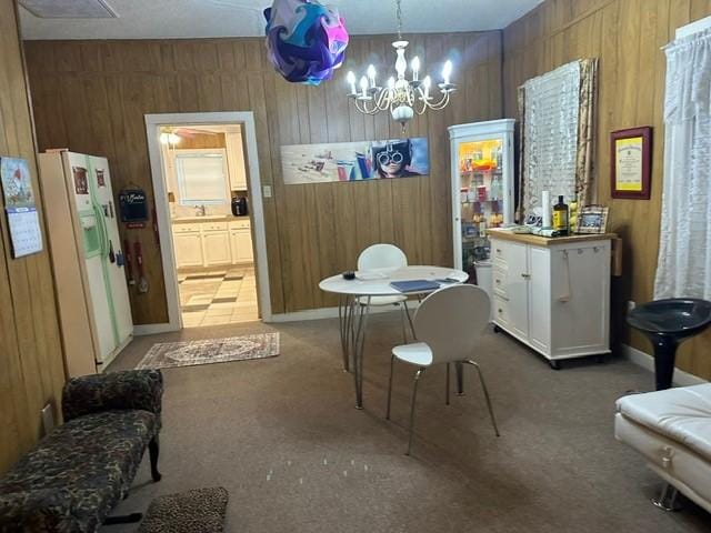 301 Dogwood Ave, Princeton, TX 75407 - dining area featuring wood walls, light colored carpet, and a chandelier