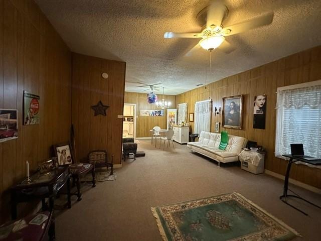 301 Dogwood Ave, Princeton, TX 75407 - living area with a textured ceiling, carpet, a ceiling fan, and wooden walls