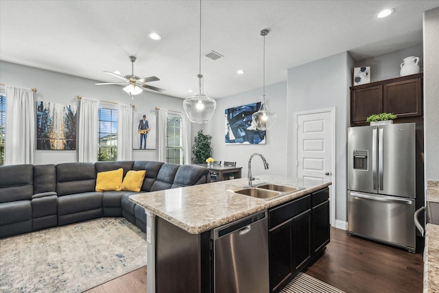 1946 Bel Air Dr, Arlington, TX 76010 - kitchen with a sink, stainless steel appliances, dark wood finished floors, dark brown cabinetry, and recessed lighting