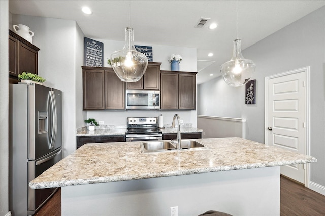 1946 Bel Air Dr, Arlington, TX 76010 - kitchen featuring stainless steel appliances, a sink, dark brown cabinets, dark wood-type flooring, and recessed lighting
