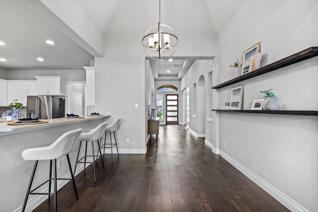 1128 Lake Hills Trl, Roanoke, TX 76262 - foyer featuring dark wood finished floors, a chandelier, baseboards, recessed lighting, and arched walkways