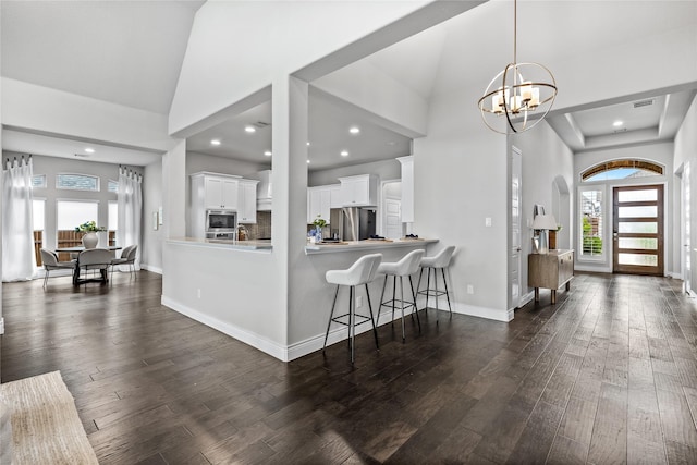 1128 Lake Hills Trl, Roanoke, TX 76262 - foyer entrance featuring plenty of natural light, dark wood-style floors, a chandelier, high vaulted ceiling, and recessed lighting