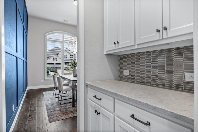 1128 Lake Hills Trl, Roanoke, TX 76262 - kitchen with dark wood-type flooring, decorative backsplash, white cabinetry, and light stone countertops
