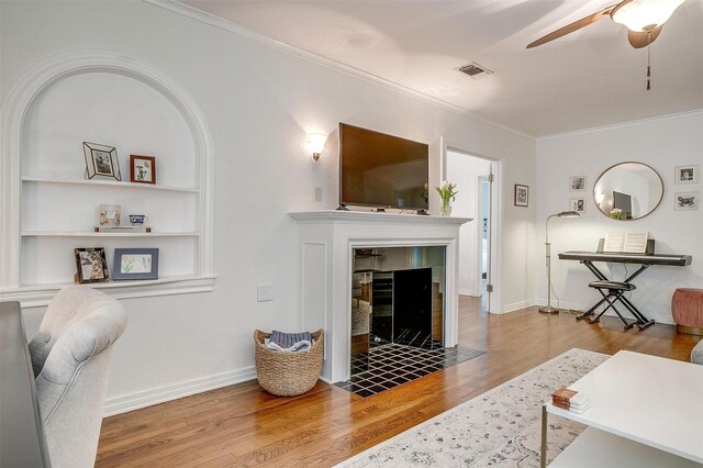 4016 El Campo Ave, Fort Worth, TX 76107 - living area featuring a ceiling fan, ornamental molding, wood finished floors, a tile fireplace, and baseboards