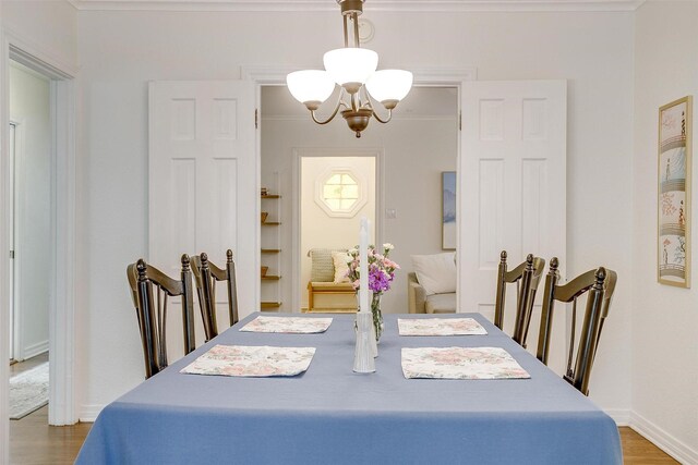 4016 El Campo Ave, Fort Worth, TX 76107 - dining space featuring a chandelier, wood finished floors, ornamental molding, and baseboards