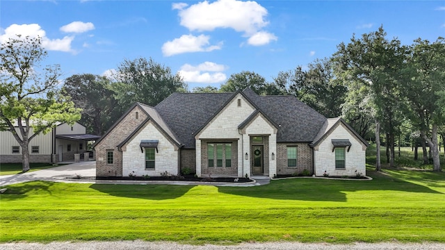 221 Greene Rd, Weatherford, TX 76087 - french country inspired facade with stone siding, a front lawn, and roof with shingles