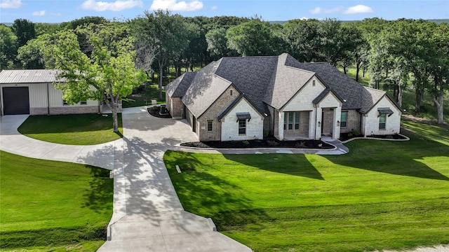 221 Greene Rd, Weatherford, TX 76087 - french country style house with stone siding, a front yard, and curved driveway