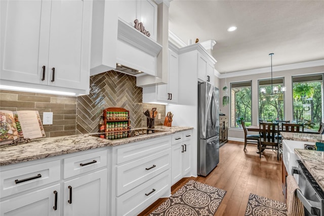 221 Greene Rd, Weatherford, TX 76087 - kitchen with freestanding refrigerator, black electric cooktop, dishwasher, ornamental molding, and white cabinets