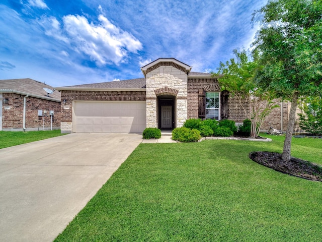 905 Jonius Creek Dr, Little Elm, TX 75068 - french country style house featuring an attached garage, driveway, a front yard, stone siding, and roof with shingles