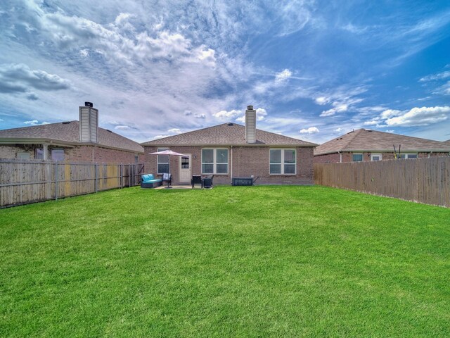 905 Jonius Creek Dr, Little Elm, TX 75068 - rear view of property with brick siding and a chimney