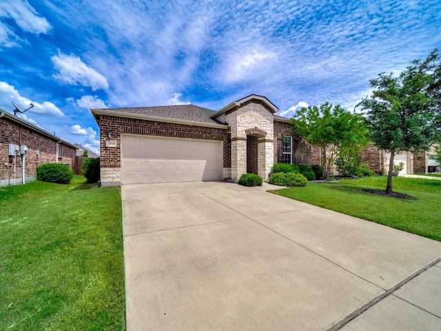 905 Jonius Creek Dr, Little Elm, TX 75068 - view of front of property with a garage, driveway, a front lawn, brick siding, and a shingled roof